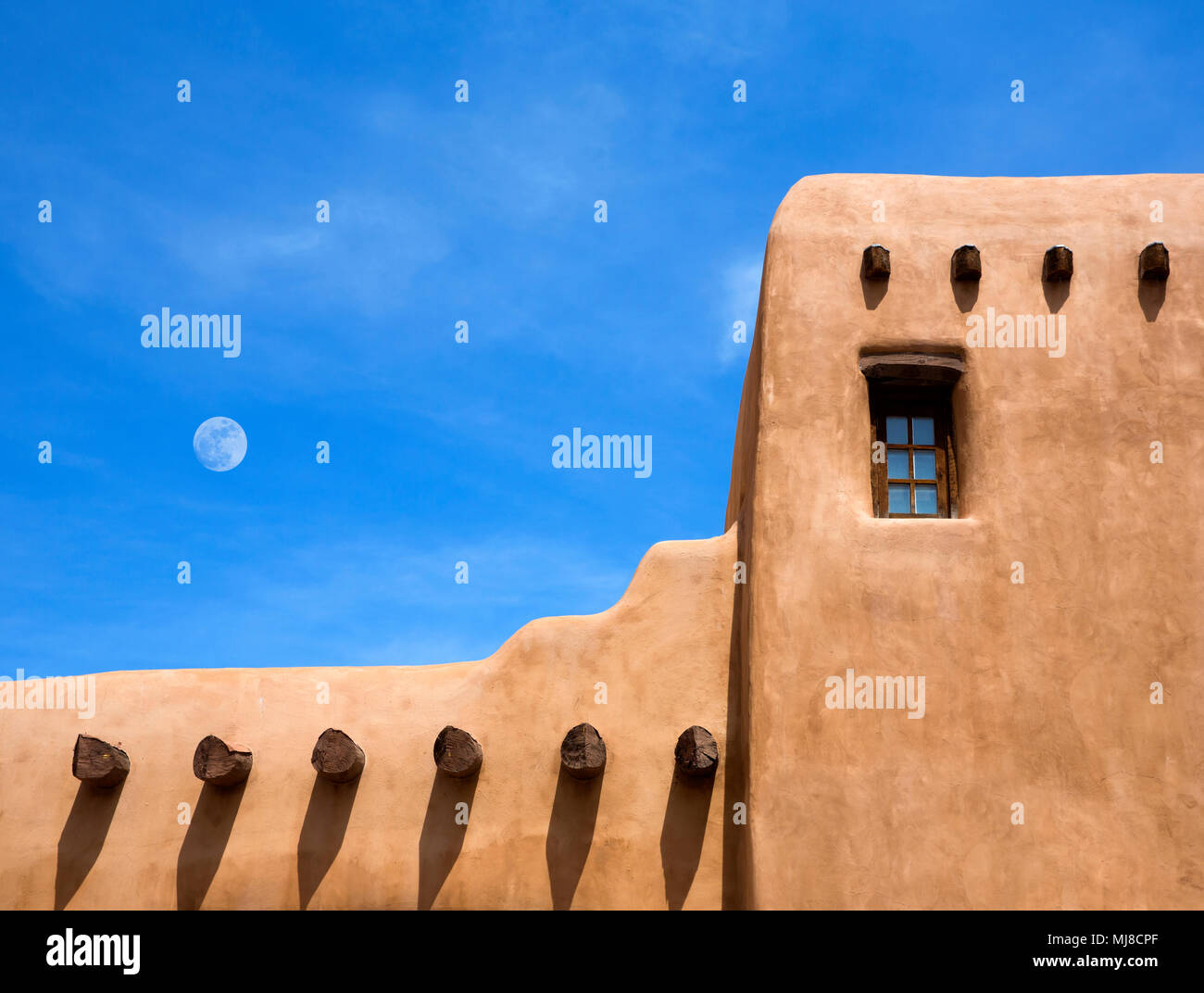 Detail of wall of traditional African mud dwelling, with window and protruding beams. Stock Photo