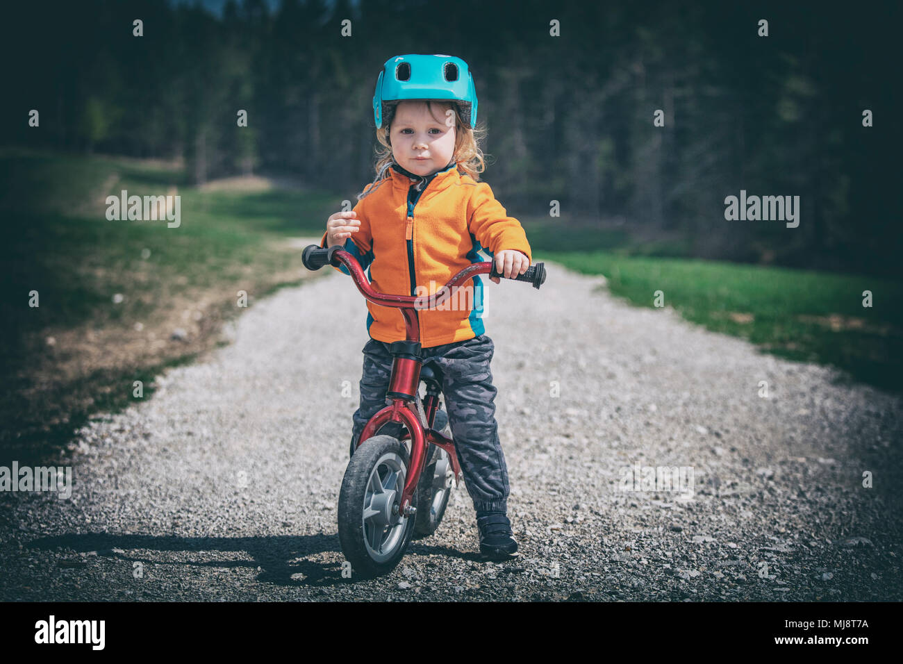 cute little girl training cycling on rural road lomo style picture Stock Photo