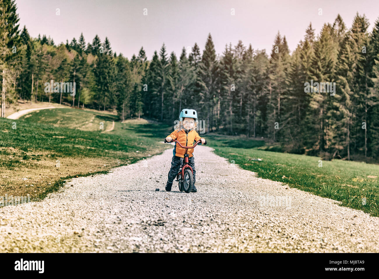 little female kid ready to start training with her bicycle Stock Photo