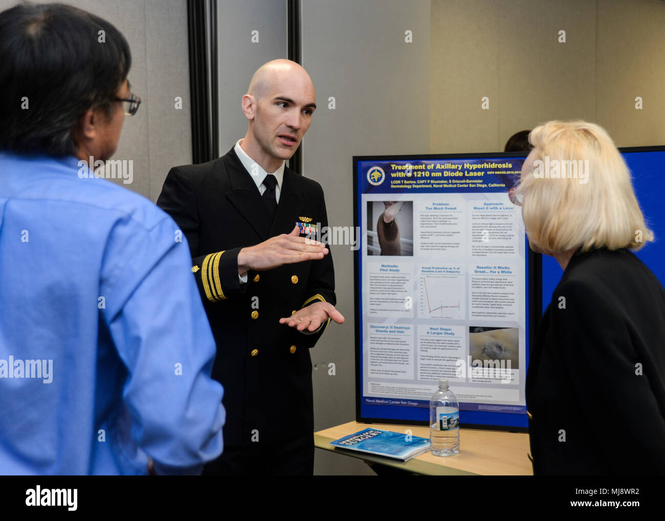 180420-N-PN275-1018 SAN DIEGO (April 20, 2018)  Lt. Cmdr.  Thomas Barlow, a dermatologist at Naval Medical Center San Diego talks about his presentation at the 33rd annual Academic Research Competition. The competition lets residents and doctors to competitively showcase their research with speeches and board displays. (U.S. Navy Photo by Mass Communication Specialist 2nd Class Zachary Kreitzer) Stock Photo