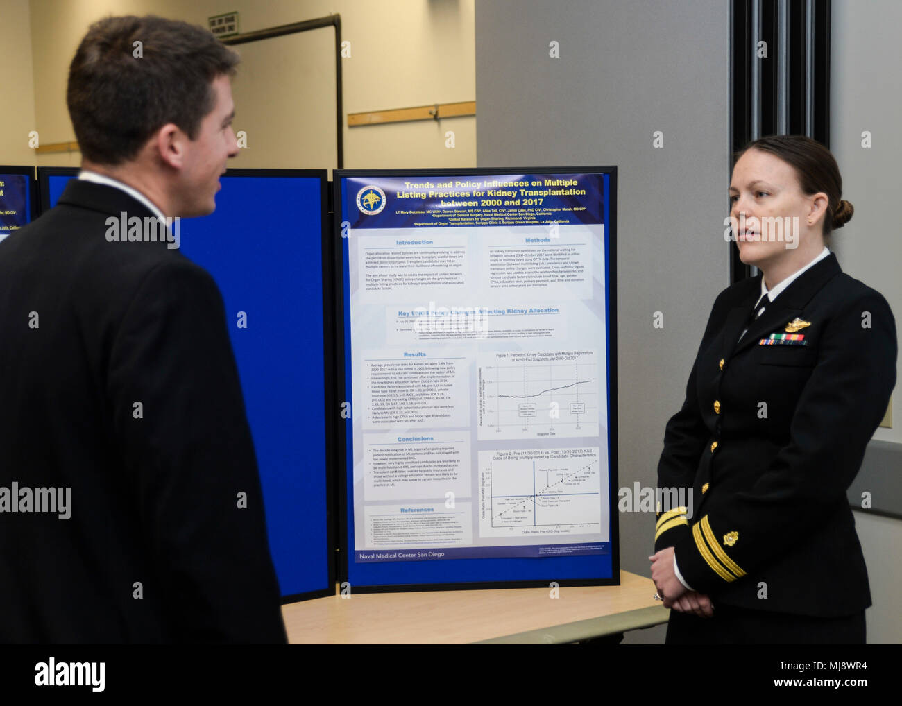 180420-N-PN275-1019 SAN DIEGO (April 20, 2018)  Lt. Mary Decoteau, a general surgery resident at Naval Medical Center San Diego, discusses her presentation with another physician  at the 33rd annual Academic Research Competition. The competition lets residents and doctors to competitively showcase their research with speeches and board displays.(U.S. Navy Photo by Mass Communication Specialist 2nd Class Zachary Kreitzer) Stock Photo