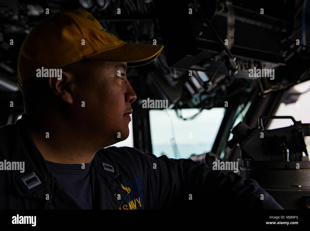180421-N-BD308-0045 OKINAWA, Japan (April 21, 2018) Lt. Leighton Rodrigo stands watch in the bridge aboard the amphibious assault ship USS Wasp (LHD 1) as the ship prepares to moor in Okinawa to disembark the 31st Marine Expeditionary Unit. Wasp, part of the Wasp Expeditionary Strike Group, has been operating with the MEU for nearly two months as part of a routine patrol in the Indo-Pacific. (U.S. Navy photo by Mass Communication Specialist 3rd Class Levingston Lewis/Released) Stock Photo