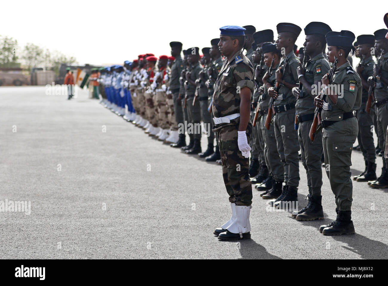 Nigerien troops stand in formation prior to the start of the closing ceremony of Flintlock 2018 in Niamey, Niger, April 20, 2018. Flintlock is an annual, African-led, integrated military and law enforcement exercise that has strengthened key partner nation forces throughout North and West Africa as well as western Special Operations Forces since 2005. (U.S. Army Photo by Sgt. Heather Doppke/79th Theater Sustainment Command) Stock Photo