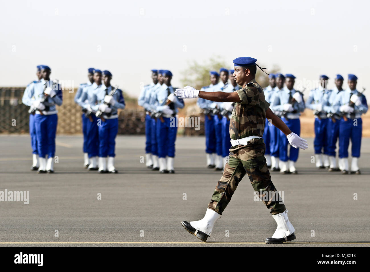 A Nigerien Soldier marches across the airfield at the start of the closing ceremony of Flintlock 2018 in Niamey, Niger, April 20, 2018. Flintlock, hosted by Niger, with key outstations at Burkina Faso and Senegal, is designed to strengthen the ability of key partner nations in the region to counter violent extremist organizations, protect their borders, and provide security for their people. (U.S. Army Photo by Sgt. Heather Doppke/79th Theater Sustainment Command) Stock Photo