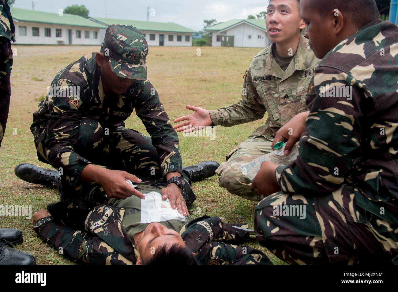 U.S. Army Sgt. John Angeles, combat medic, Charlie Company, 2nd Brigade  Support Battalion, 2-2 Stryker Brigade Combat Team, 2nd Infantry Division,  and Philippine Army soldiers with 95th Infantry Battalion, 5th Infantry  Division