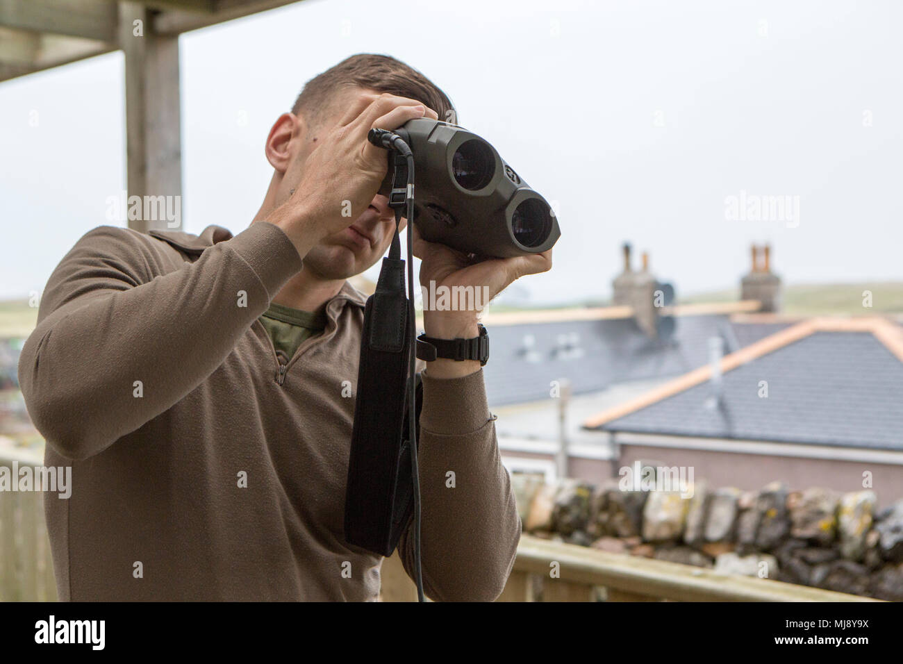 Sgt. Michael Peers, a firepower control team chief with 4th Air Naval Gunfire Liaison Company, Force Headquarters Group, calibrates a vector so he can find the distance and direction of, and for, a target, in Durness, Scotland, April 22, 2018. 4th ANGLICO is in Scotland to take part in Joint Warrior 18-1, an exercise that furthers their readiness and effectiveness in combined arms integration, small unit tactics and land navigation. This training aims at improving their capabilities and combat effectiveness and ensures they're ready to fight tonight. Stock Photo