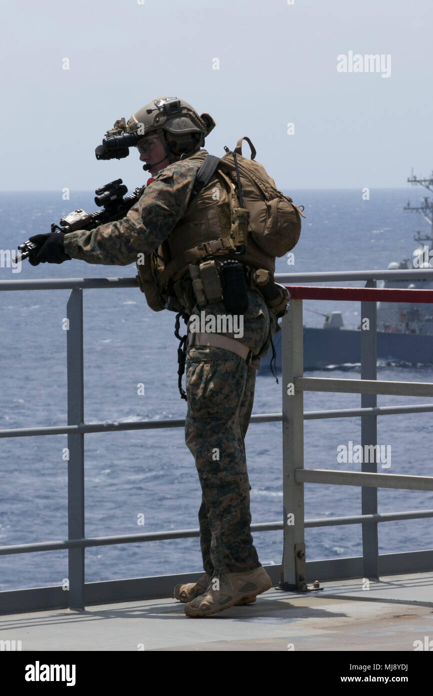 A Force Reconnaissance Marine with Maritime Raid Force, 31st Marine Expeditionary Unit, holds security as Marines conduct Visit, Board, Search, and Seizure training during Certification Exercise aboard the USNS Richard E. Byrd (T-AKE 4), while underway in the Pacific Ocean, April 20, 2018. MRF Marines train regularly for quick, tactical raids of targets on both land and sea. The 31st MEU and Amphibious Squadron 11 conduct CERTEX as the final evaluation in a series of training exercises which ensures readiness for crisis response throughout the Indo-Pacific region. (U.S. Marine Corps photo by L Stock Photo