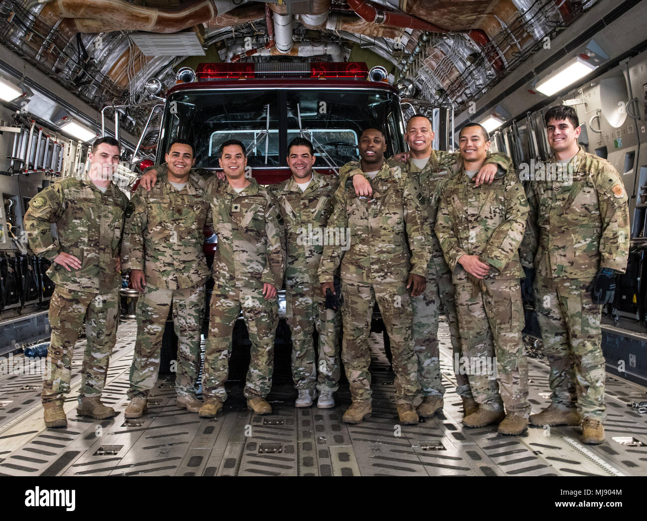 U.S. Airmen with the 21st Airlift Squadron and the 860th Aircraft Maintenance Squadron pose for a photo while delivering Denton Program emergency response vehicles at La Aurora International Airport, Guatemala City, Guatemala, April 20, 2018. The Denton Program is a Department of Defense transportation program that moves humanitarian cargo, donated by U.S. based Non-Governmental Organizations to developing nations to ease human suffering. The emergency vehicles were donated by the Mission of Love Foundation, they are the largest user of the Denton Program, having delivered medical, relief and  Stock Photo