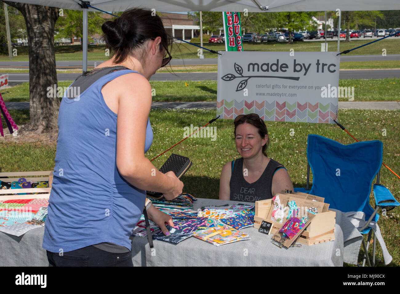 Tara Cason, right, owner of made by trc, sells homemade crafts during