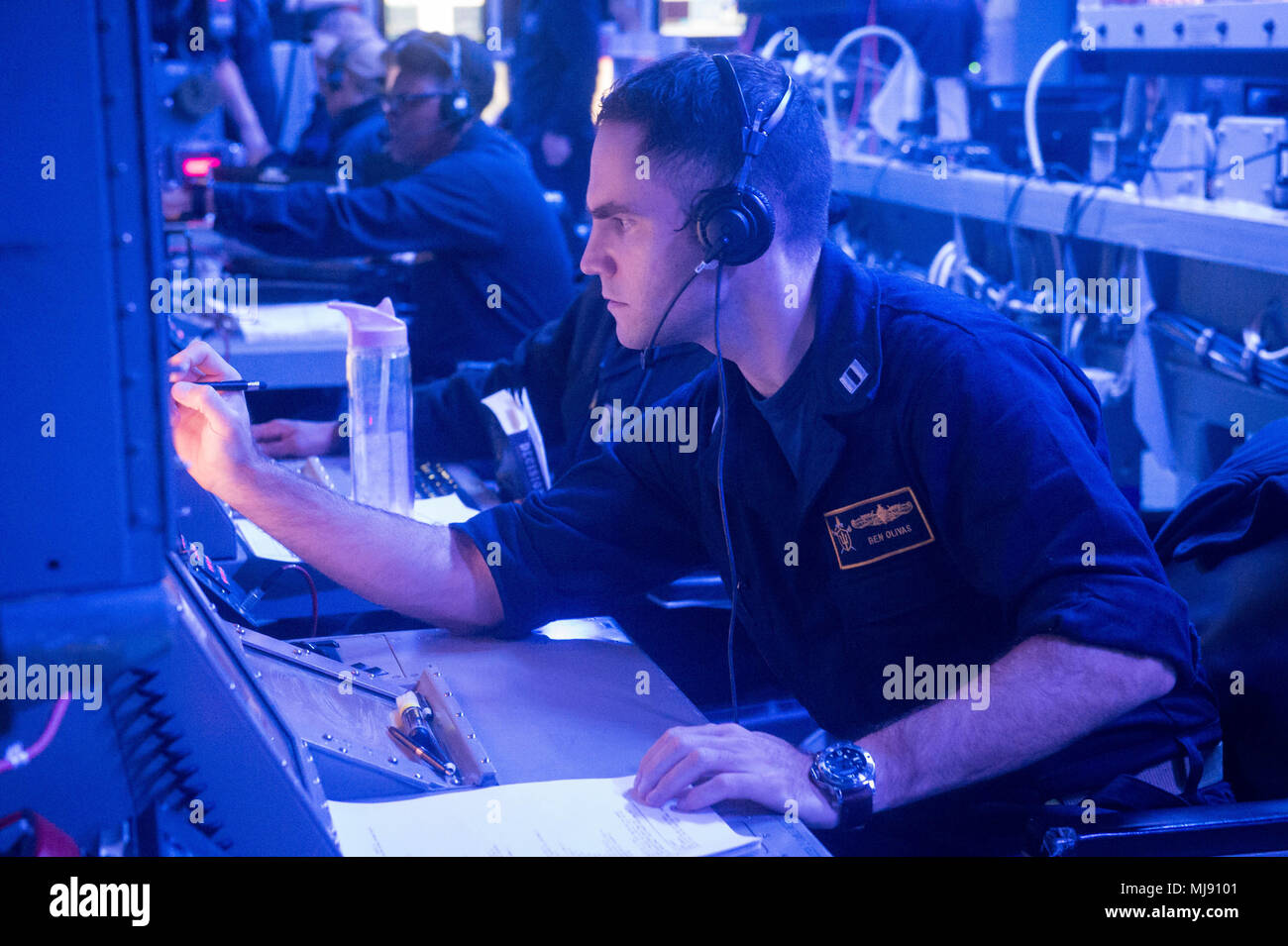 Pacific Ocean (April 20, 2018) Lieutenant Ben Olivas, a Warfare Tactics Instructor (WTI), from Naval Surface and Mine Warfighting Development Center (SMWDC) prepares for an Air Defense exercise during an underway Cruiser-Destroyer (CRUDES) Surface Warfare Advanced Tactical Training (SWATT) exercise aboard USS Stockdale (DDG 106).  Stockdale is one of three CRUDES warships from USS John C. Stennis (CVN 74) Carrier Strike Group (CSG) completing a CRUDES SWATT exercise.  The other ships participating in the Naval Surface and Mine Warfighting Development Center (SMWDC) led exercise are USS Mobile  Stock Photo