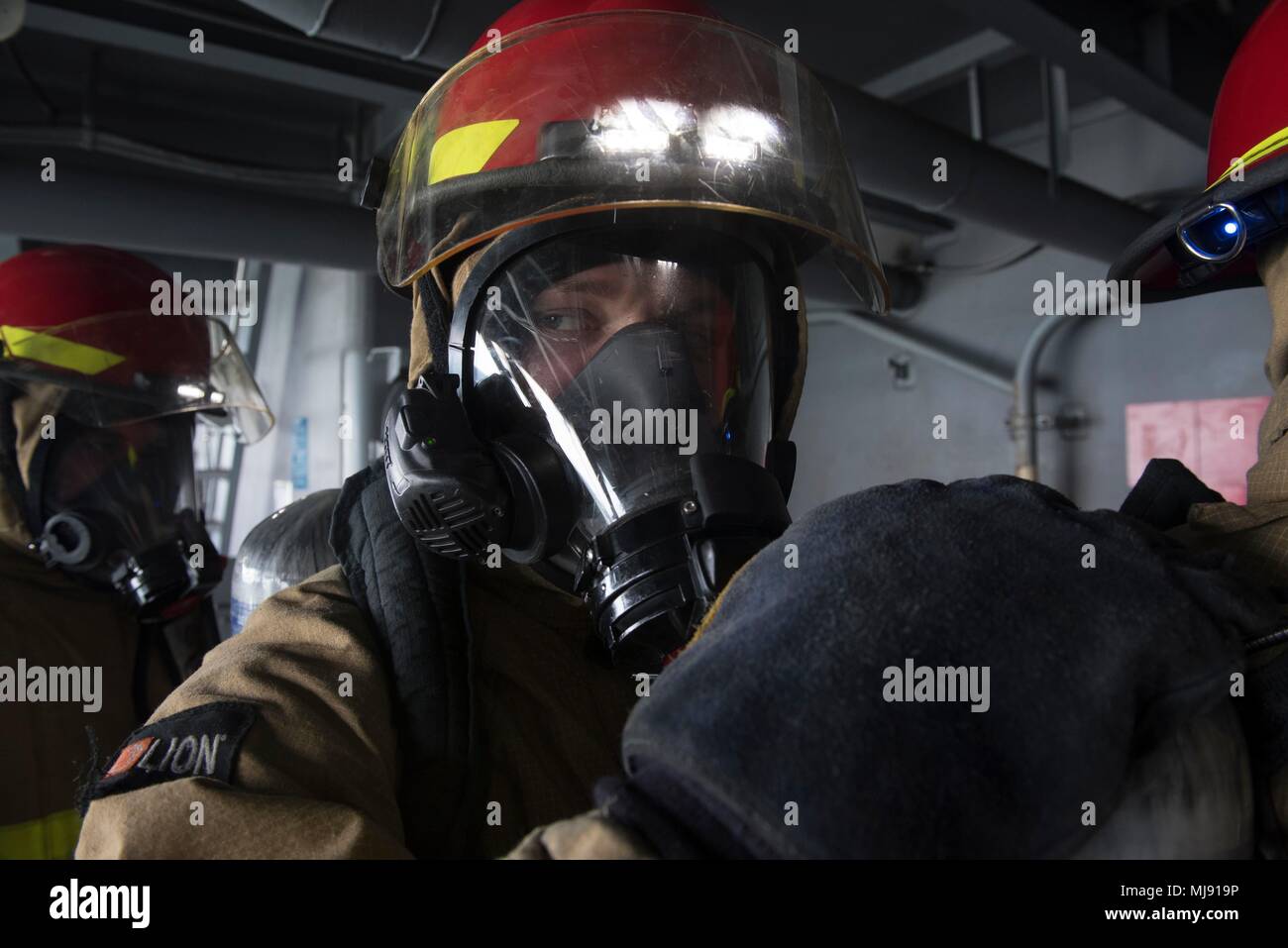 180421-N-ZH683-166 ATLANTIC OCEAN (Apr. 21, 2018) Aviation Machinist's Mate Airman Brandon Parmalee mans a fire team on a weather deck during a general quarters drill aboard USS Harry S. Truman (CVN 75). Truman is currently deployed as part of an ongoing rotation of U.S. forces supporting maritime security operations in international waters around the globe. (U.S. Navy photo by Mass Communication Specialist 3rd Class Juan Sotolongo/Released) Stock Photo