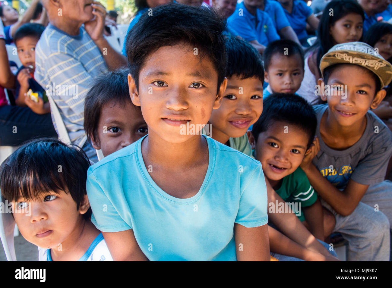 Children pose for a photo during a community relations event for ...