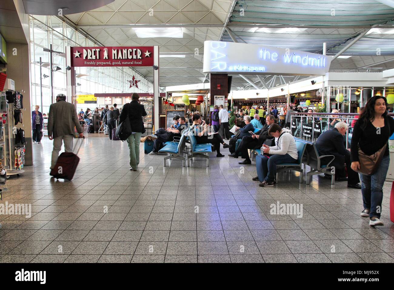 LONDON - MAY 16: Travelers wait at Stansted airport on May 16, 2012 in London. It was the 4th busiest airport in the UK with 17.4 million passengers. Stock Photo