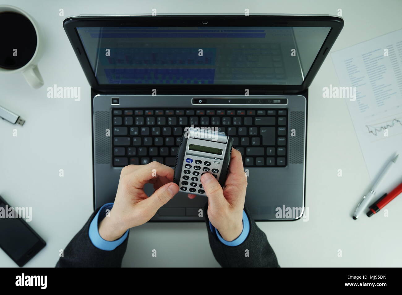Hand using laptop calculator hi-res stock photography and images - Alamy