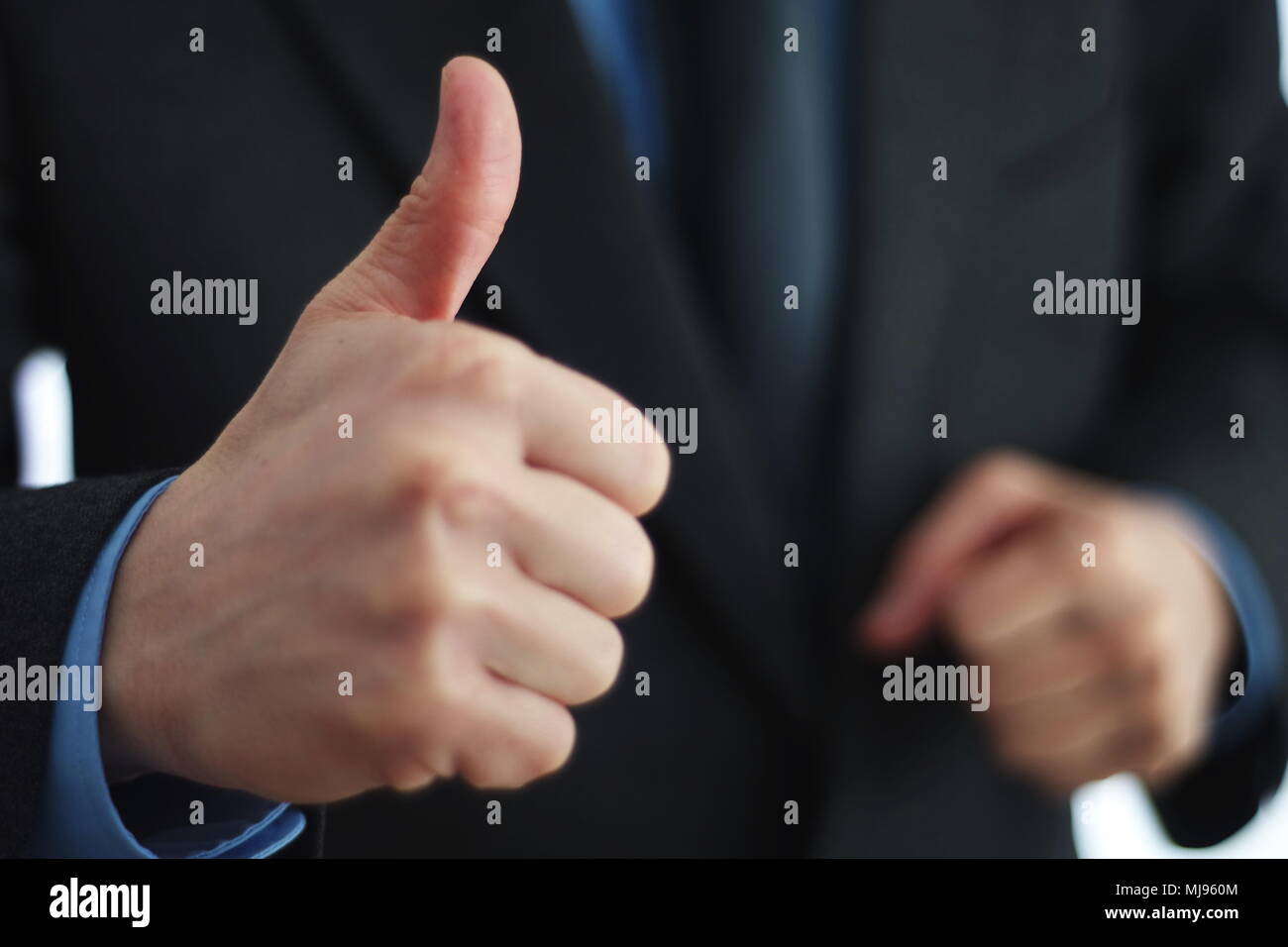 Giving thumbs up sign Stock Photo