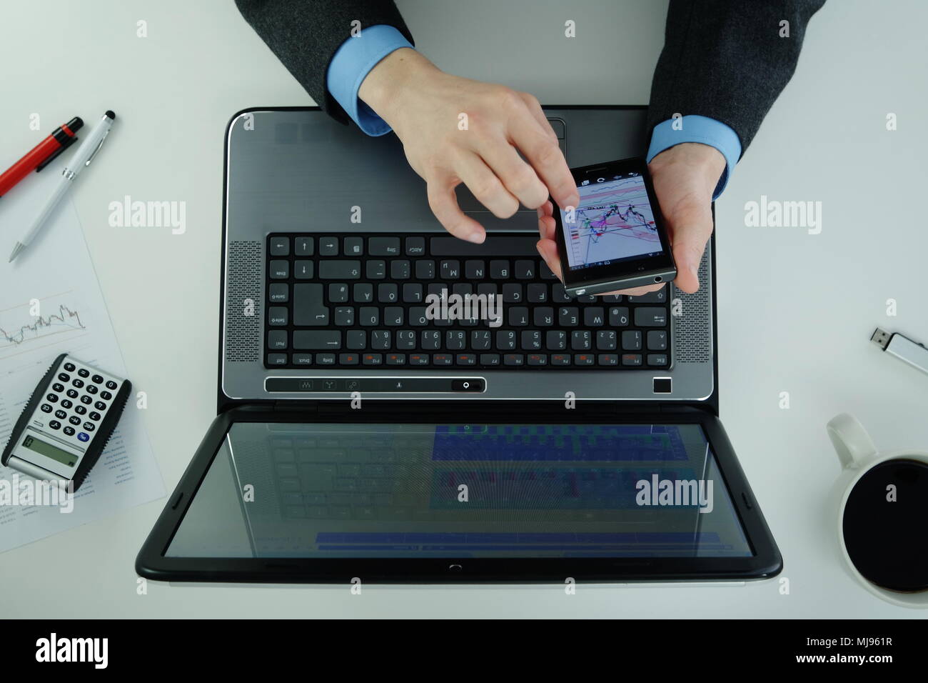 Working on a laptop and using smartphone Stock Photo