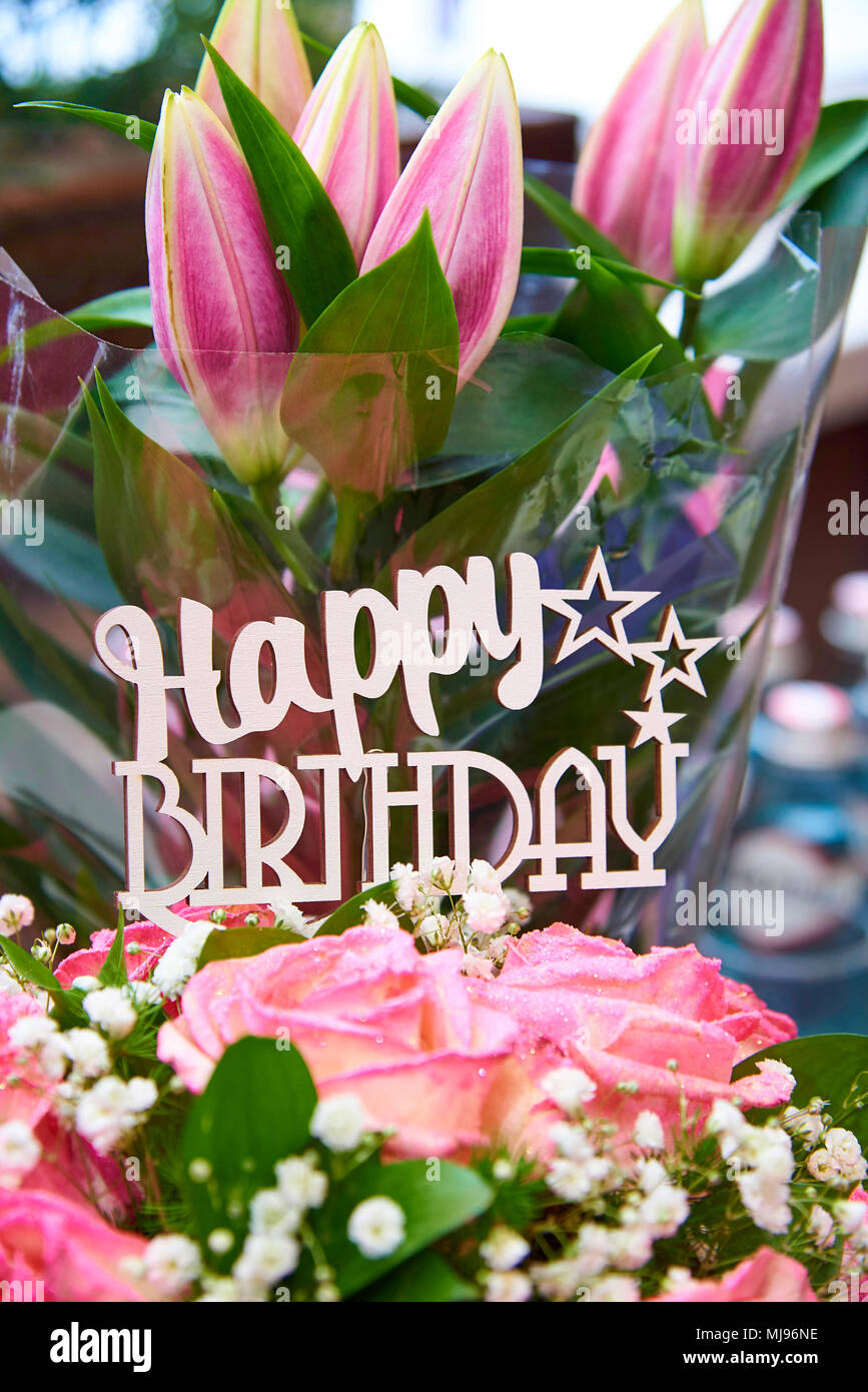 Inscription Happy Birthday in a bouquet of flowers Stock Photo - Alamy