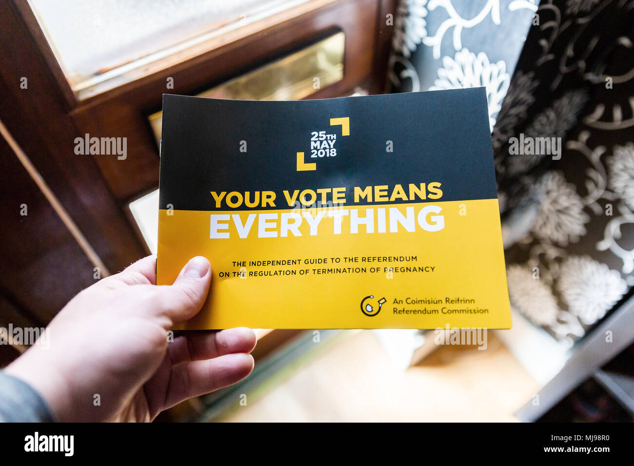 Referendum booklet being dropped in through the letterbox encouraging to vote in the upcoming 8th amendment referendum. Abortion referendum in Ireland Stock Photo