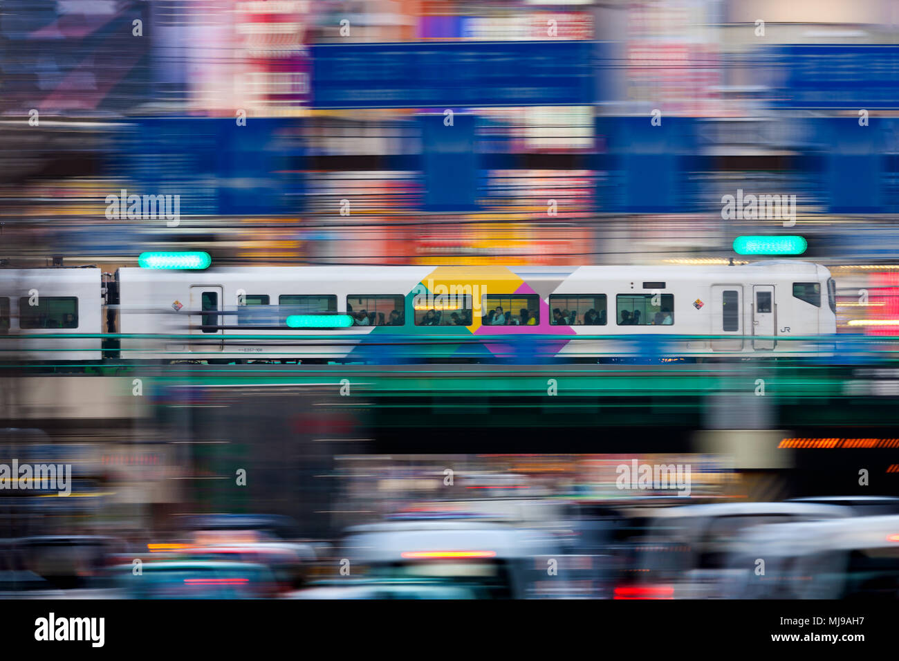 Japanese Commuter Train running over a bridge in Tokyo's Shinjuku ...