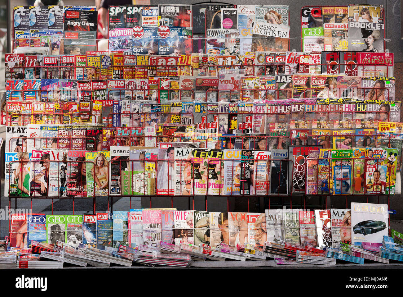 Large selection of magazines aligned on a shelf at an Austrian newsstand Stock Photo