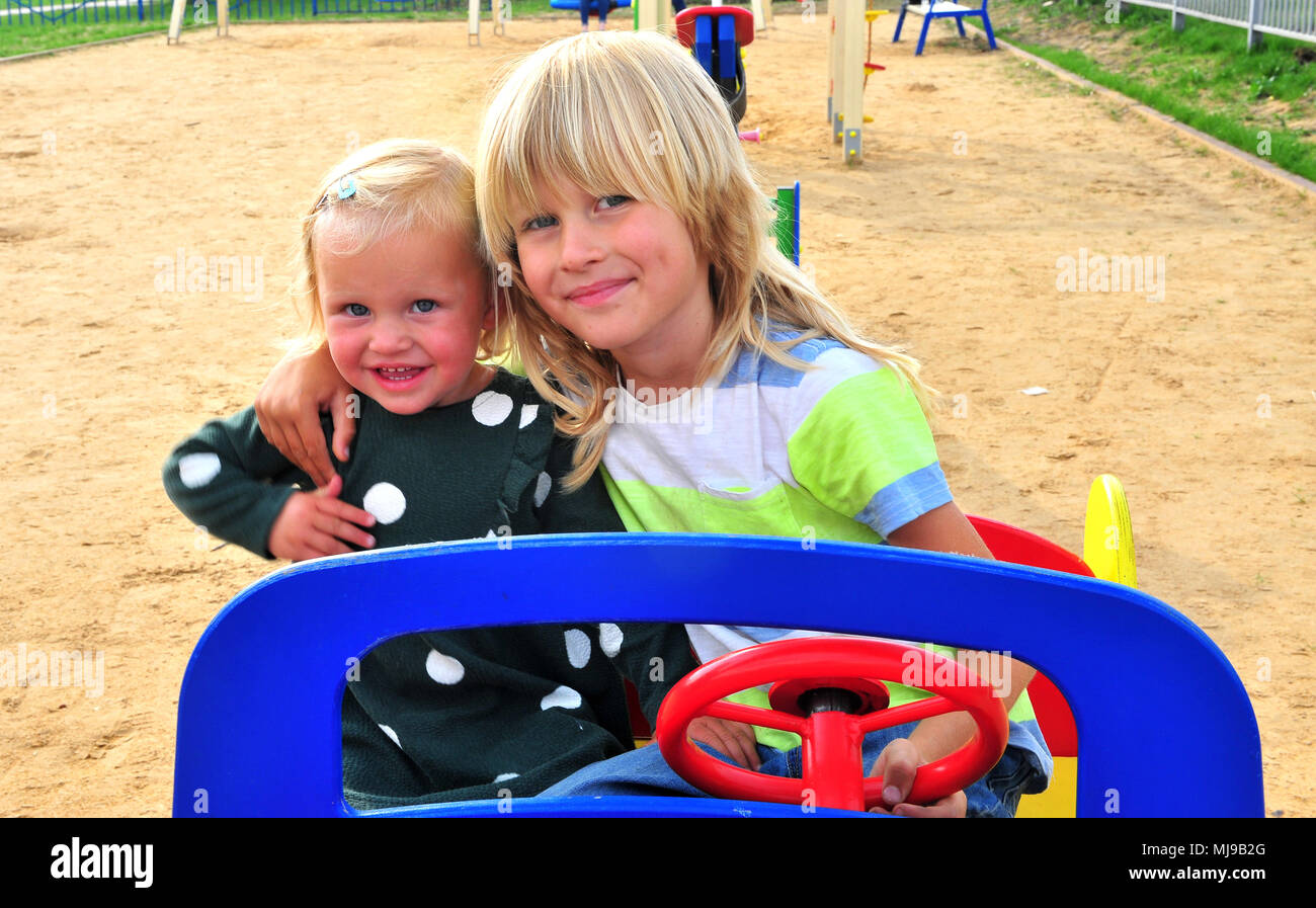 Two kids at the playground, summer scene Stock Photo - Alamy