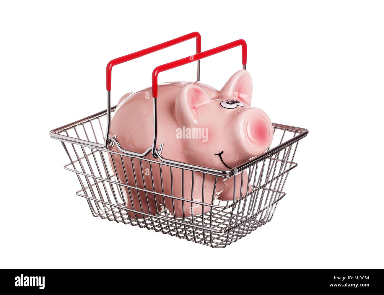 One piggy bank in a shopping basket with red handles, isolated on white. Stock Photo