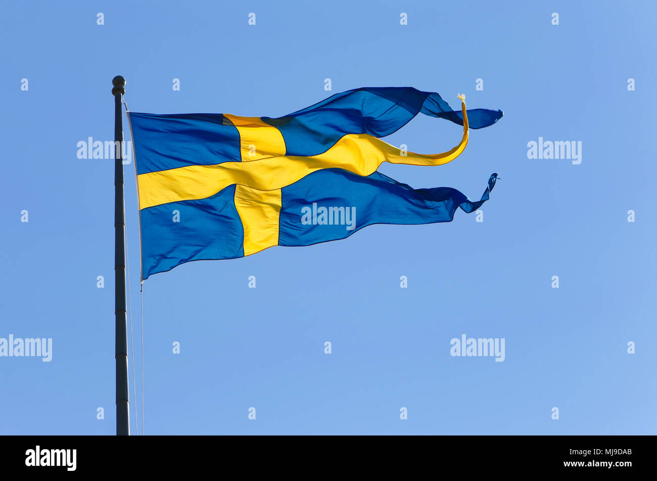 The Swedish three-tailed naval flag on blue sky. Stock Photo