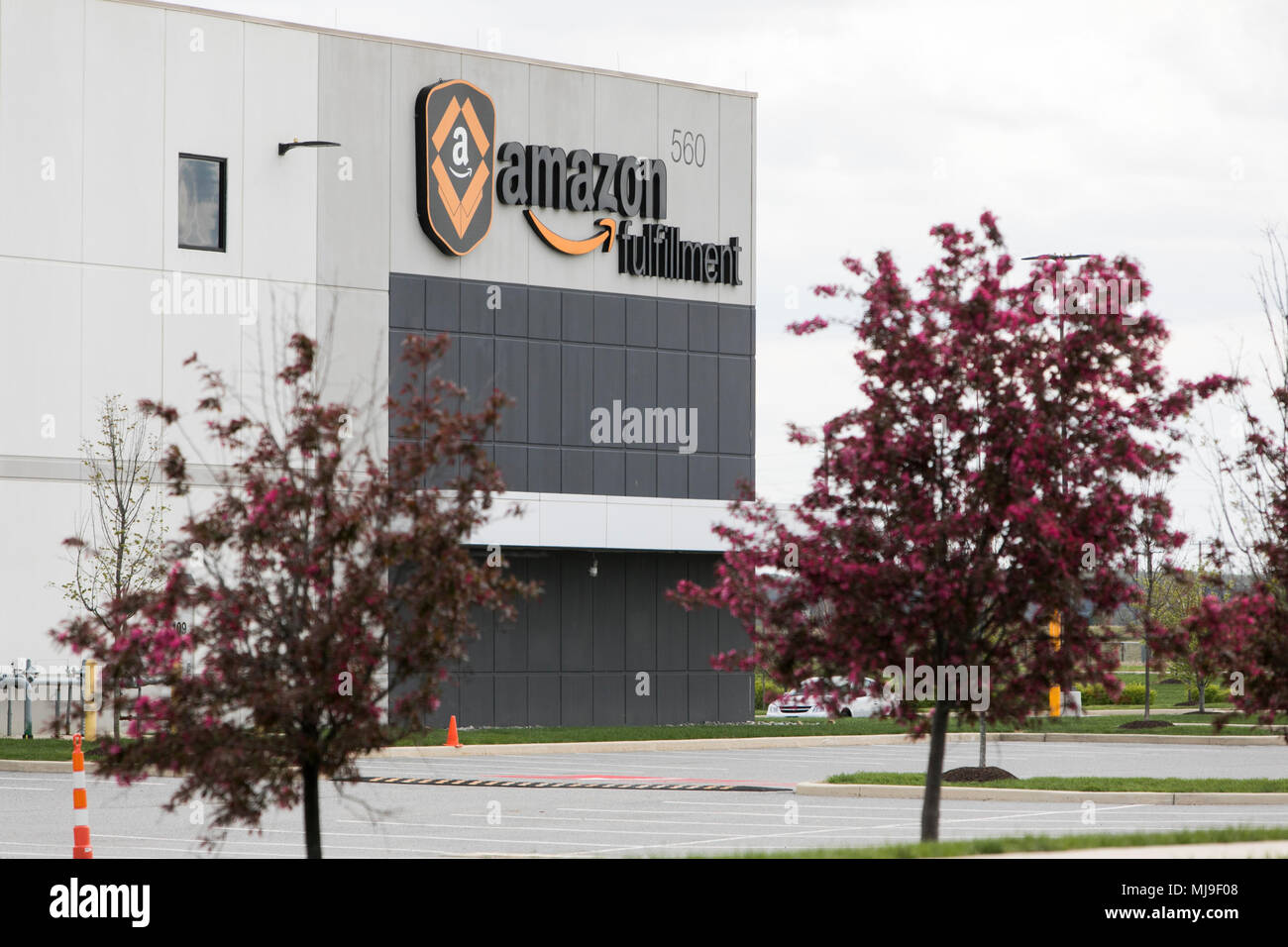 A logo sign outside of a Amazon fulfillment center in Middletown