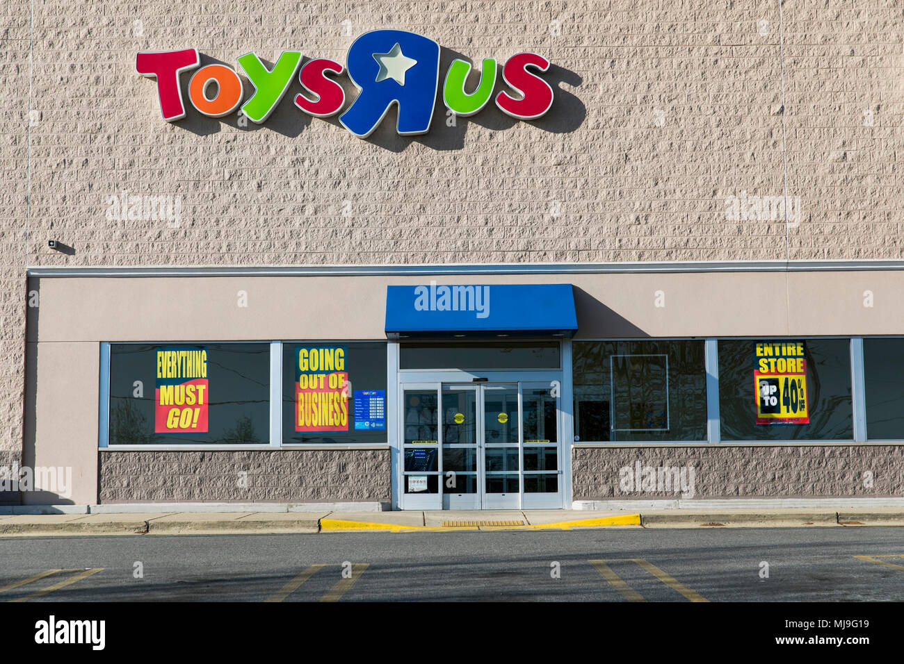 A logo sign outside of a joint Toys 'R' Us and Babies 'R' Us retail store in Annapolis, Maryland with 'Going Out Of Business' signage on April 29, 201 Stock Photo