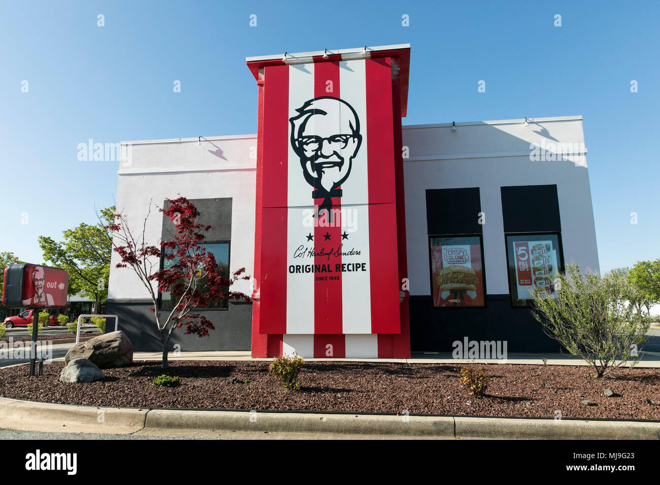 A logo sign outside of a KFC (Kentucky Fried Chicken) fast food