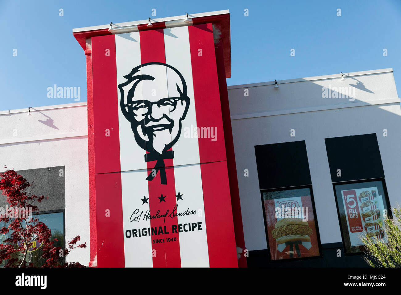 A logo sign outside of a KFC (Kentucky Fried Chicken) fast food