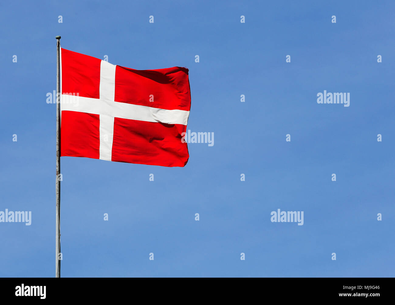 Flag of Denmark on blue sky. Stock Photo