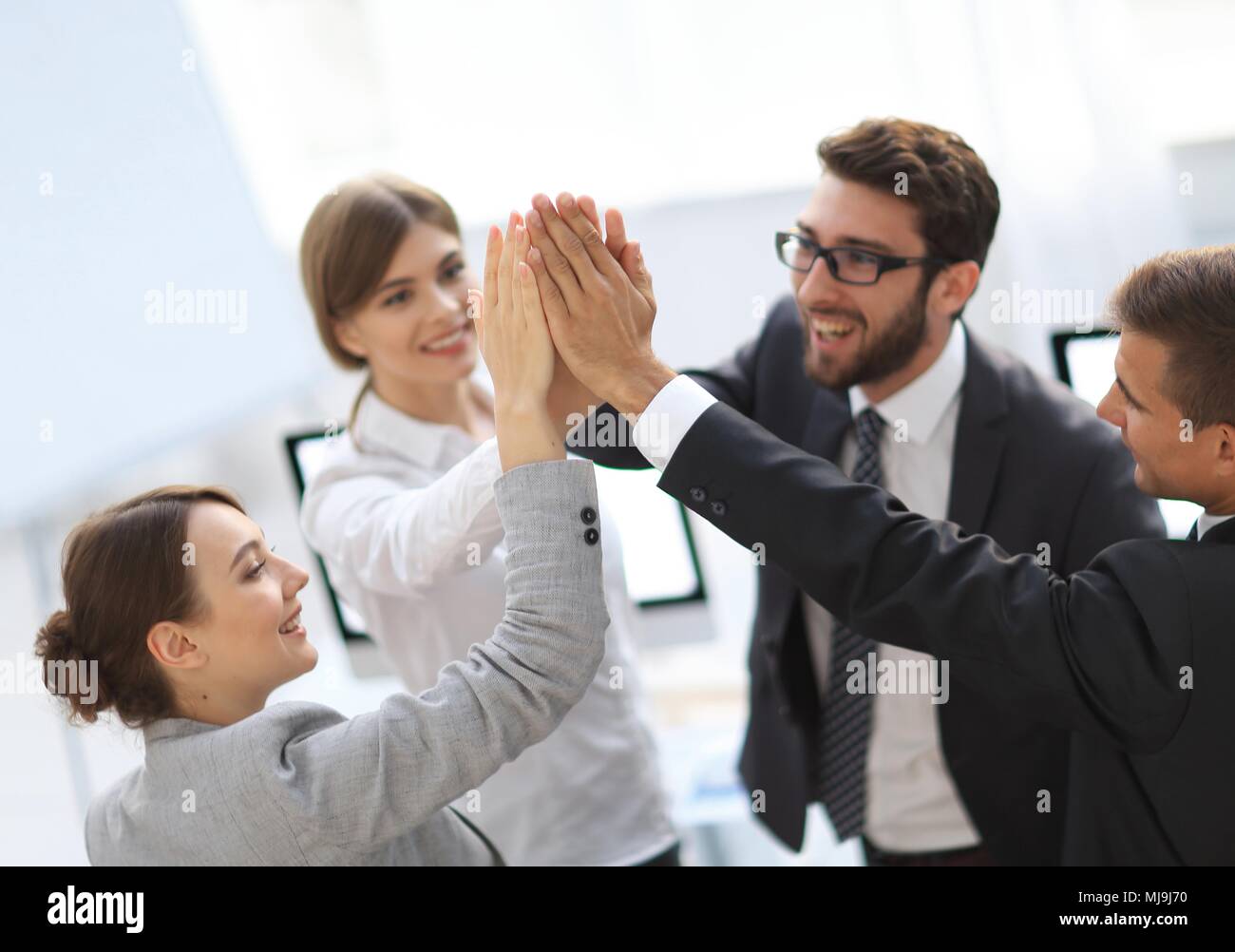 successful business team giving each other a high-five, standing in the ...