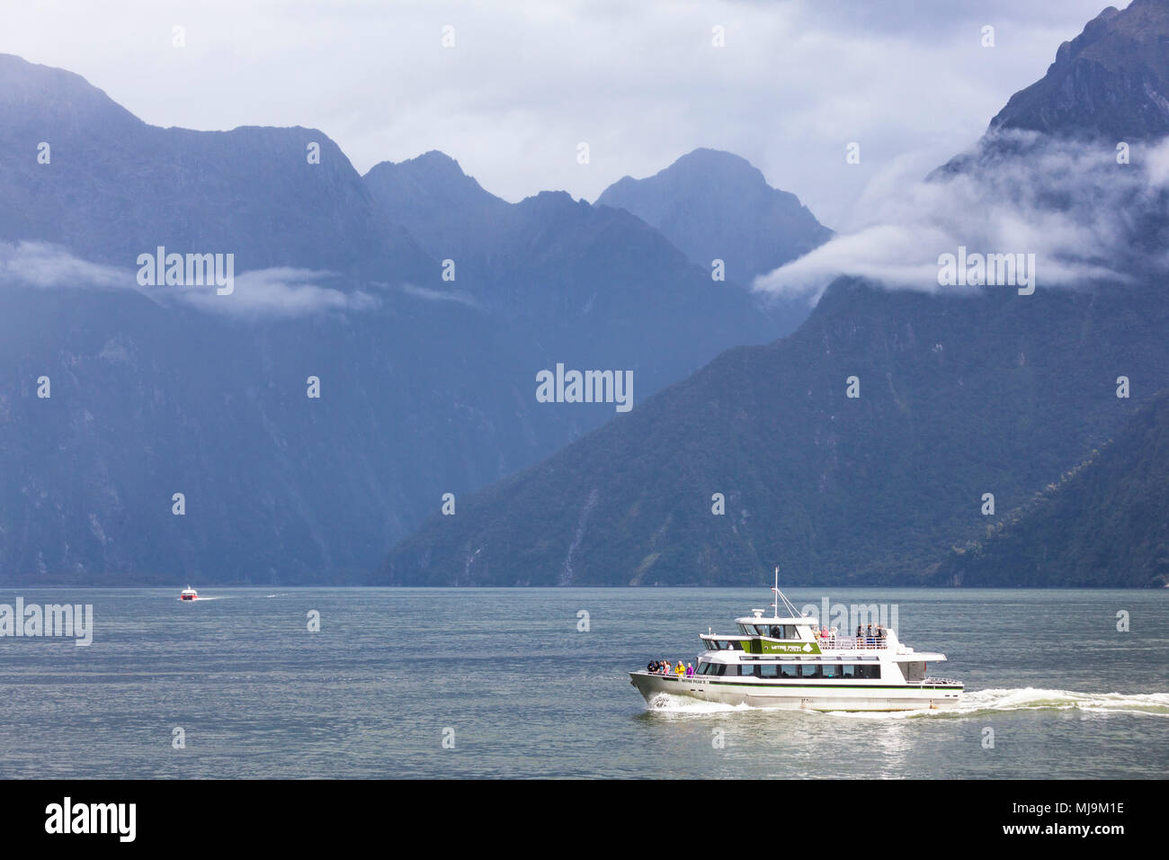 Milford sound New Zealand Milford sound boat trip on milford sound tourists returning to the cruise terminal milford sound new zealand South Island nz Stock Photo