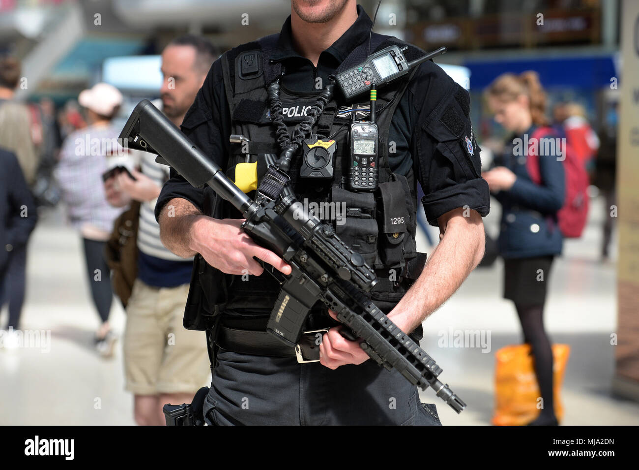 A firearms officer patrolling at Waterloo Station in London, where people will be travelling from to watch the royal wedding. Stock Photo