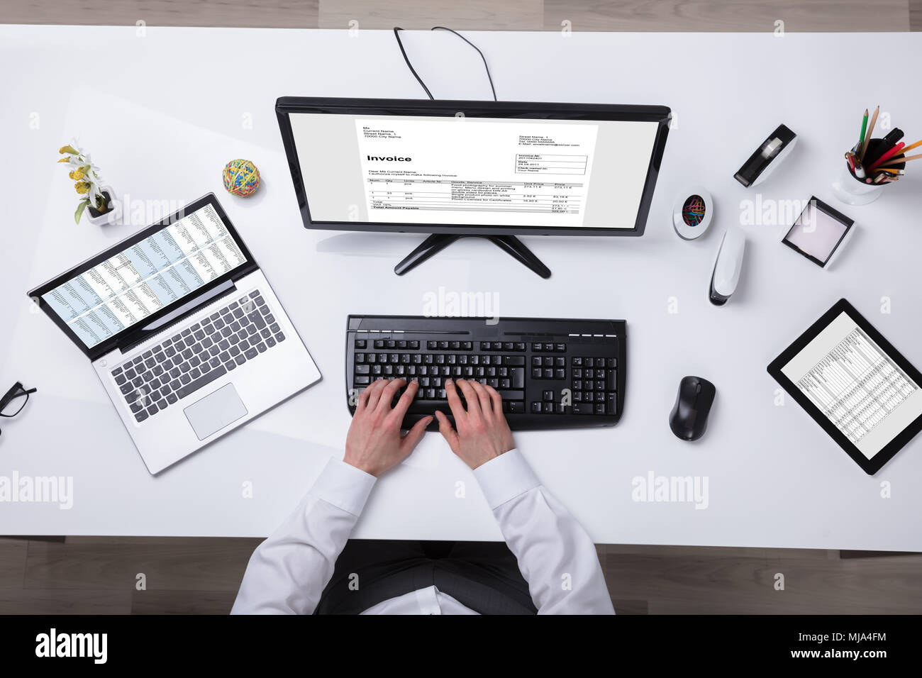 Young Businessman Using Laptop With Computer Screen Showing Invoice Stock Photo