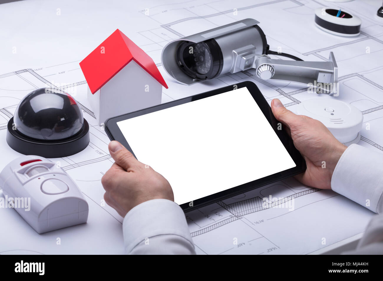 Architect's Hand Using Digital Tablet With Blank White Screen Stock Photo