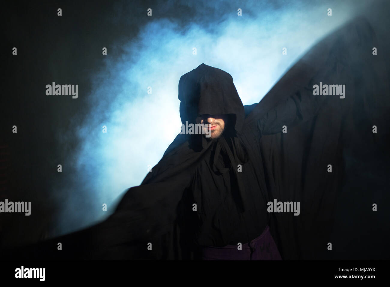 Man in black cloak with hood hi-res stock photography and images - Alamy