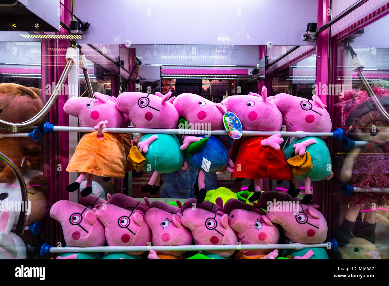 Peppa Pig plush dolls toys inside a claw machine Stock Photo - Alamy