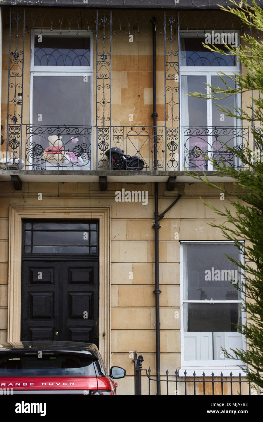 Red Range Rover (bottom left) and regency building in Cheltenham, Gloucestershire. Stock Photo