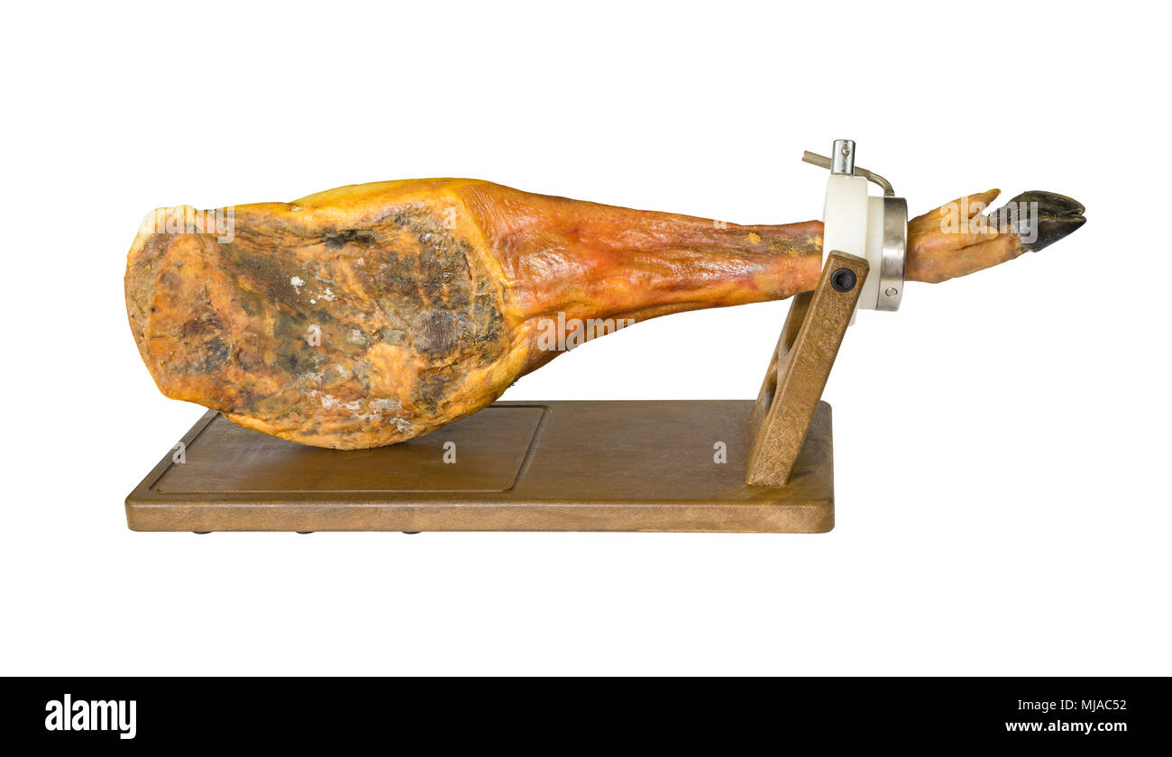 Side view of whole serrano ham leg over wood, white background Stock