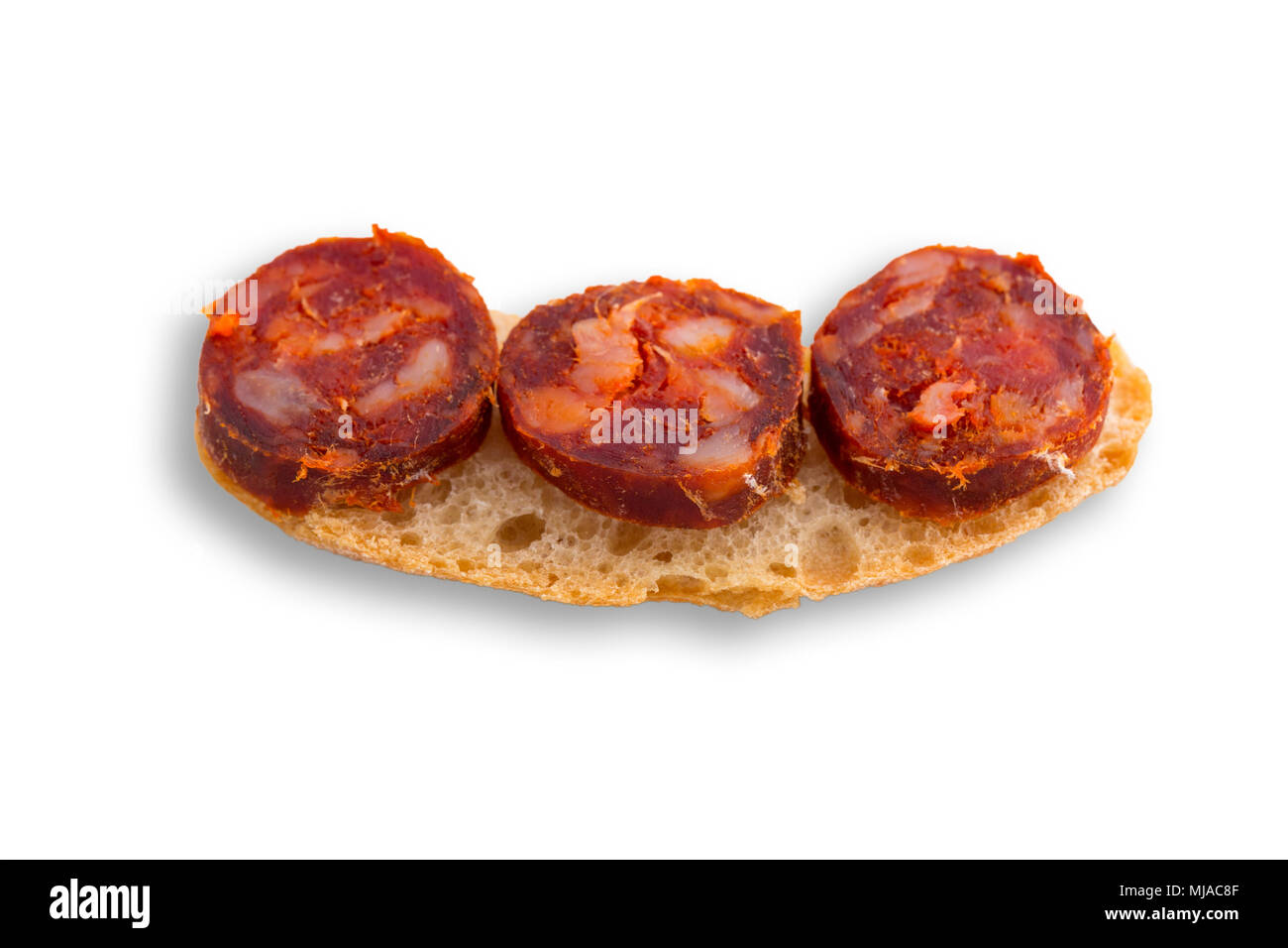 Top view of chorizo slices tapa with bread isolated on white background ...