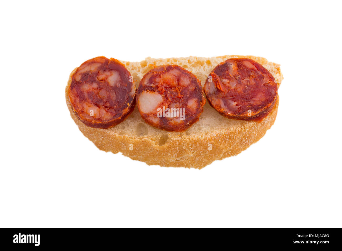 Top view of chorizo slices tapa with bread isolated on white background ...