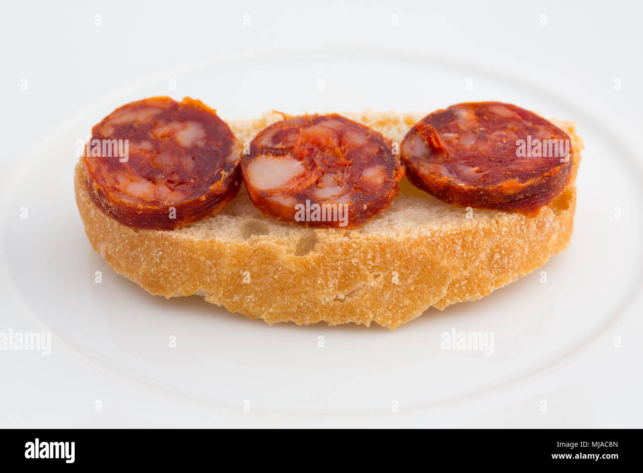 High angle view of chorizo slices tapa with bread Stock Photo - Alamy
