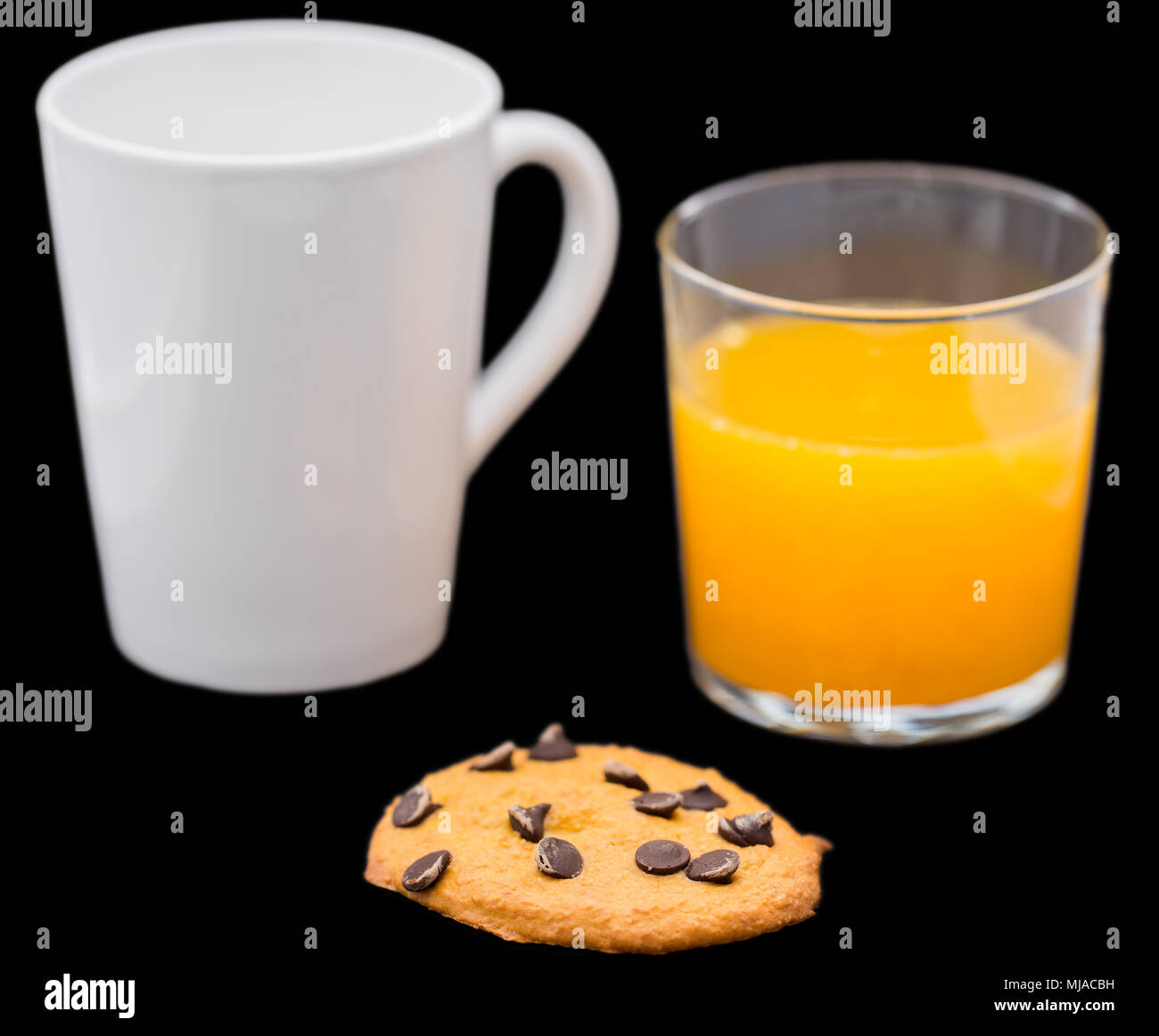 Pumpkin cookie with chocolate, orange juice and coffee, focus on cookie