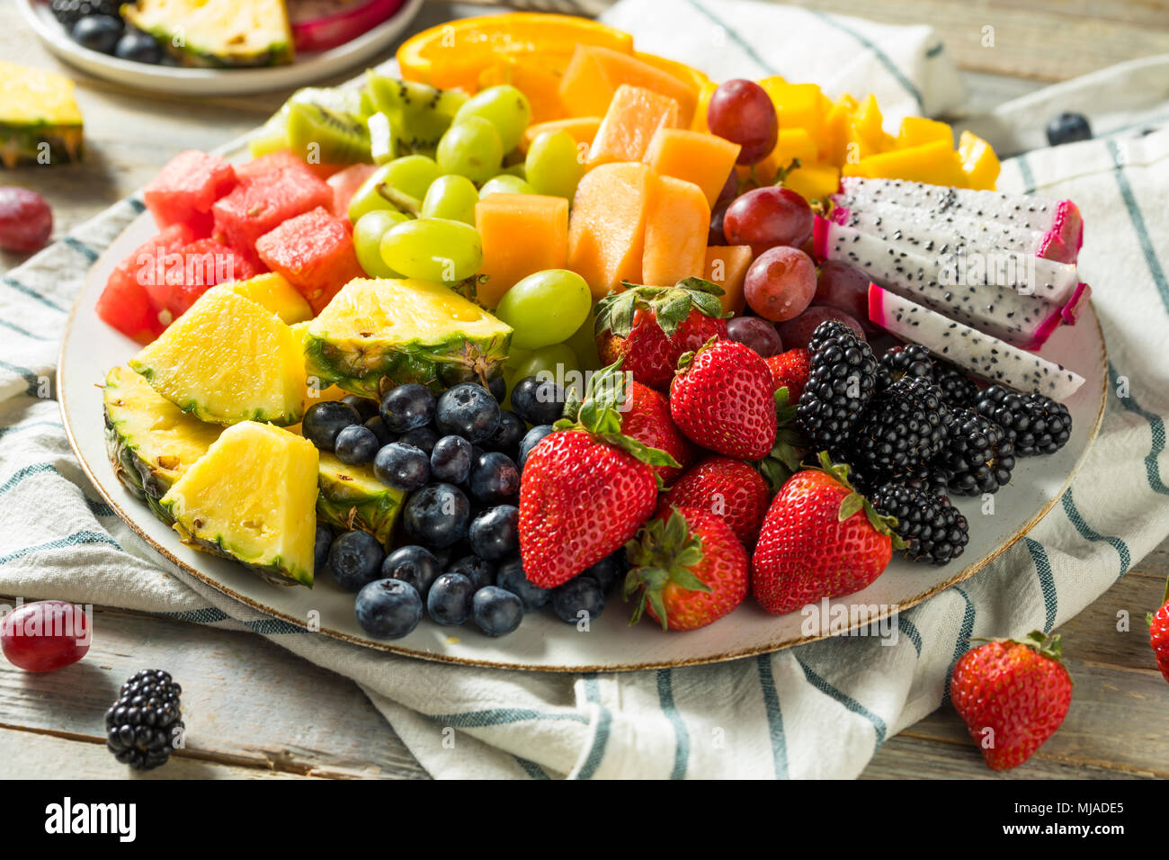 Raw Organic Fruit Platter with Berries Melons and Grapes Stock Photo