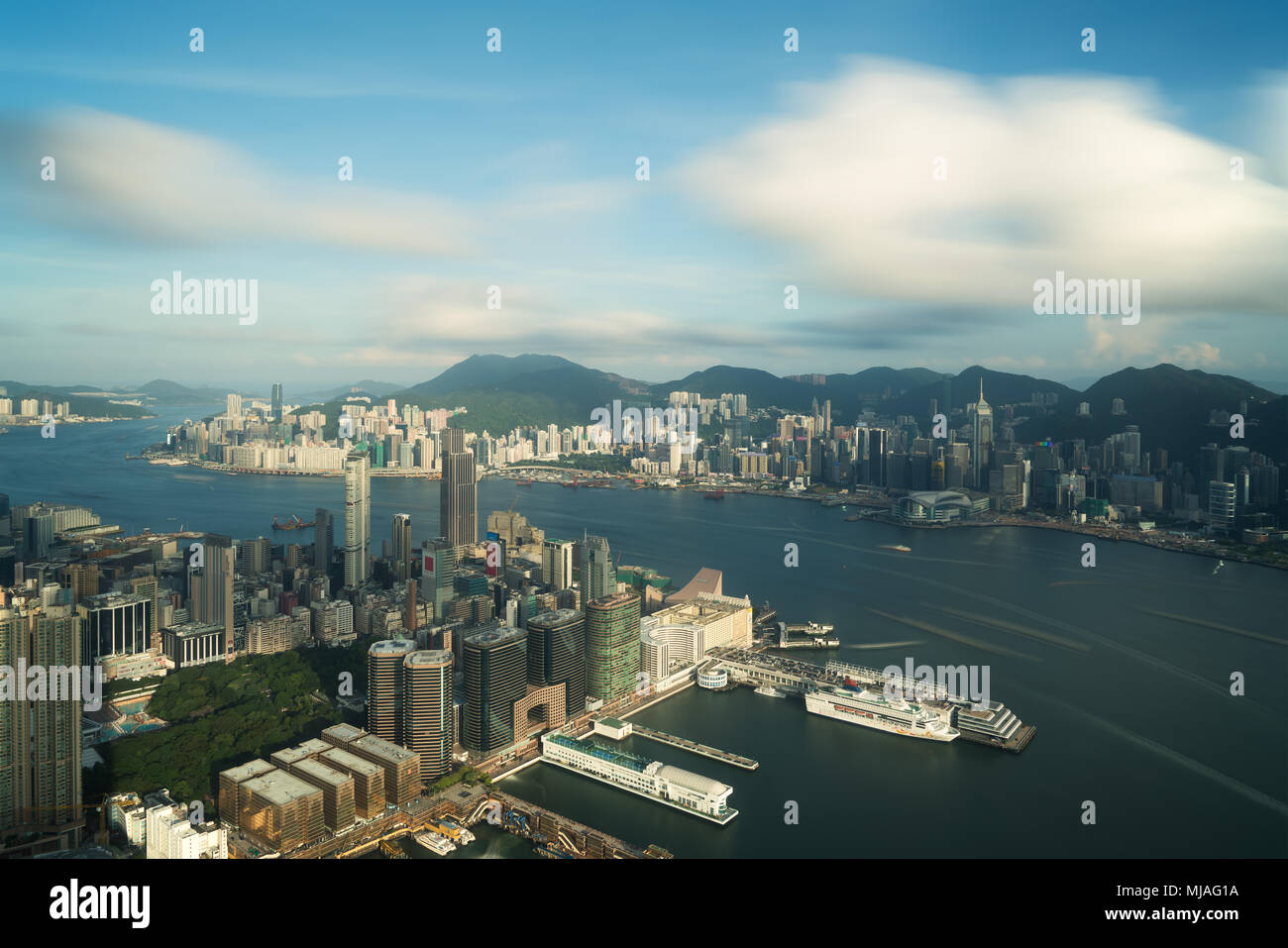 Aerial view of Hong Kong skyline and Victoria Harbor with blue sky in ...