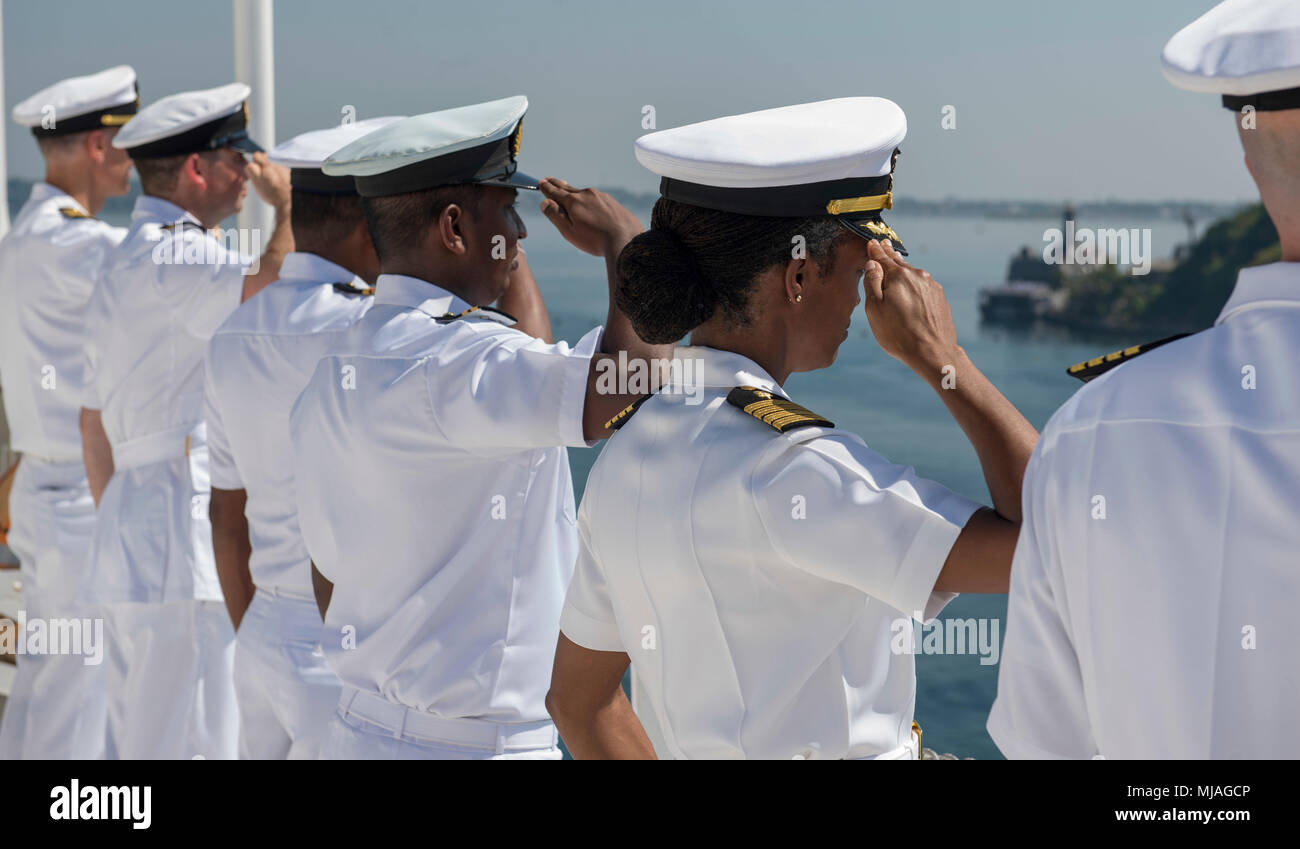 180425-N-MD713-0073   TRINCOMOLEE, Sri Lanka (April 25, 2018) Sailors and joint service members aboard Military Sealift Command hospital ship USNS Mercy (T-AH 19) render honors as the ship passes SLNS Sayurala (P623), who was in service during the Sri Lankan Civil War, en route to Trincomolee, Sri Lanka, for a scheduled port visit in support of Pacific Partnership 2018 (PP18). PP18’s mission is to work collectively with host and partner nations to enhance regional interoperability and disaster response capabilities, increase stability and security in the region, and foster new and enduring fri Stock Photo