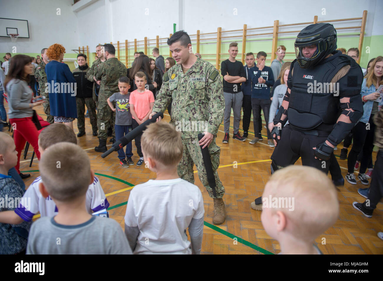 180425-N-ST458-0474 REDZIKOWO (Apr. 25, 2018) Naval Support Facility (NSF) Redzikowo sailors interact with students and host a military display at the open day event at the School Complex in Redzikowo-Osiedle. NSF Redzikowo is the Navy™s newest installation, and the first U.S. installation in Poland. Its operations enable the responsiveness of U.S. and allied forces in support of Navy Region Europe, Africa, Southwest Asia™s (NAVEURAFSWA) mission to provide services to the Fleet, Fighter, and Family. (U.S. Navy photo by Lt. Josie Lynne Lenny/Released) Stock Photo