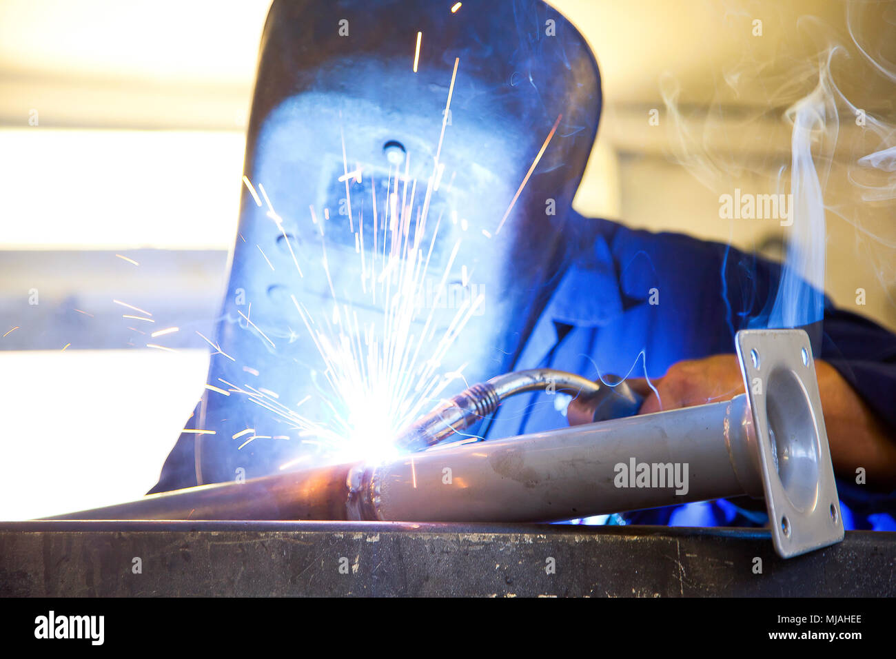 man is welding with protection Stock Photo
